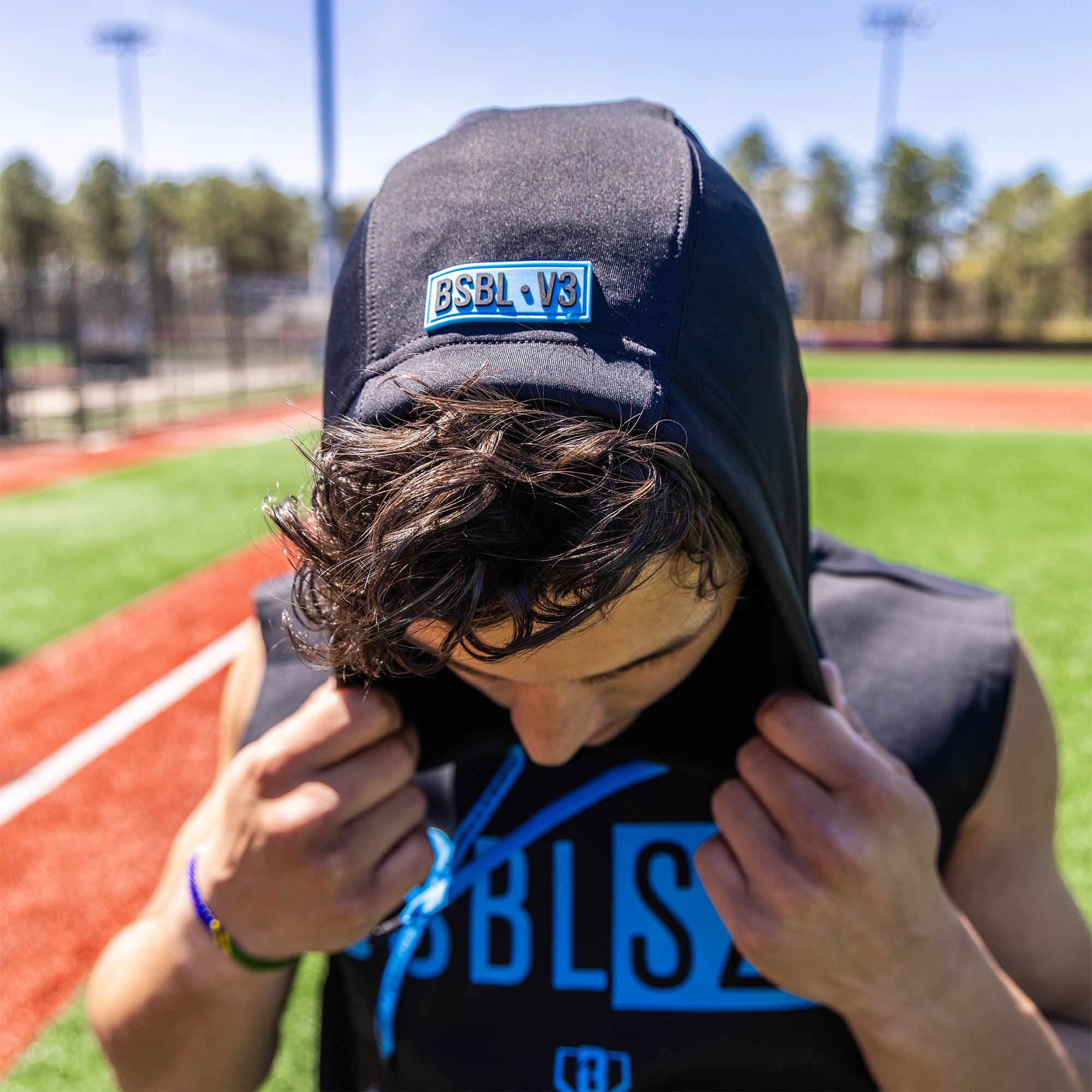Adult model wearing black and light blue BSBL-SZN Sleeveless hoodie