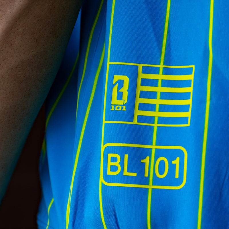 Blue shirt with yellow stripes and BL101  text and graphics, featuring the number '101' and a flag design.