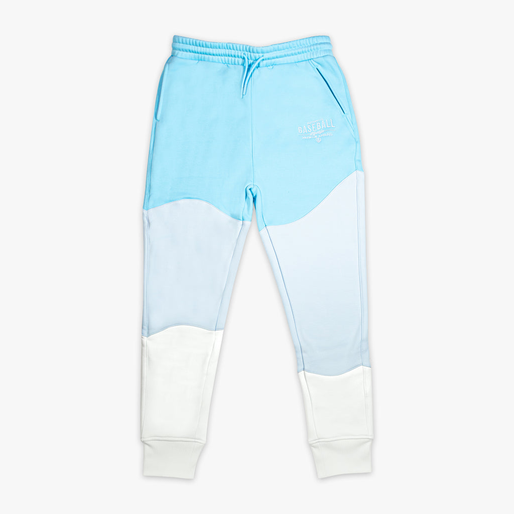 Light blue and white color-blocked sweatpants on a white background