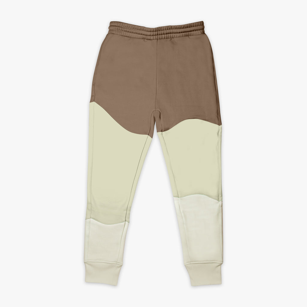Two-tone brown and beige sweatpants on a white background