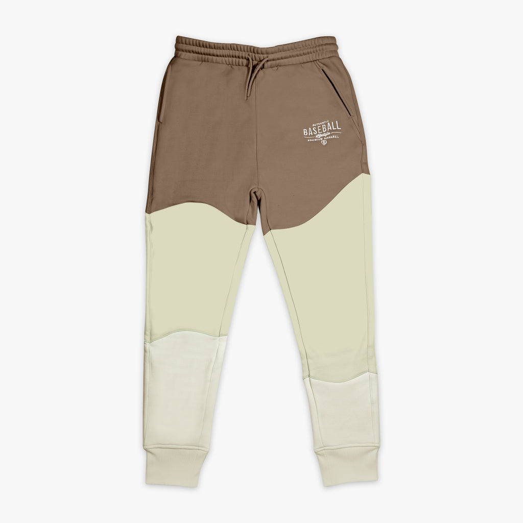Two-tone brown and beige sweatpants with a Baseball Lifestyle 101 logo on a white background