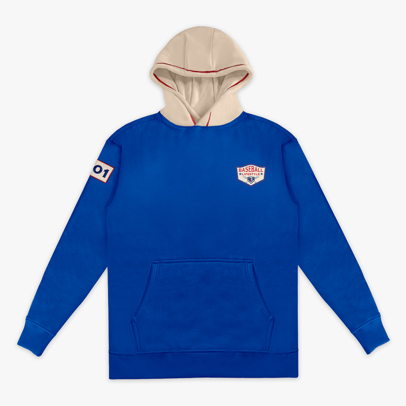 Royal blue hoodie with a cream hood, showing the Baseball Lifestyle shield chest logo, sleeve patch, on a white background.