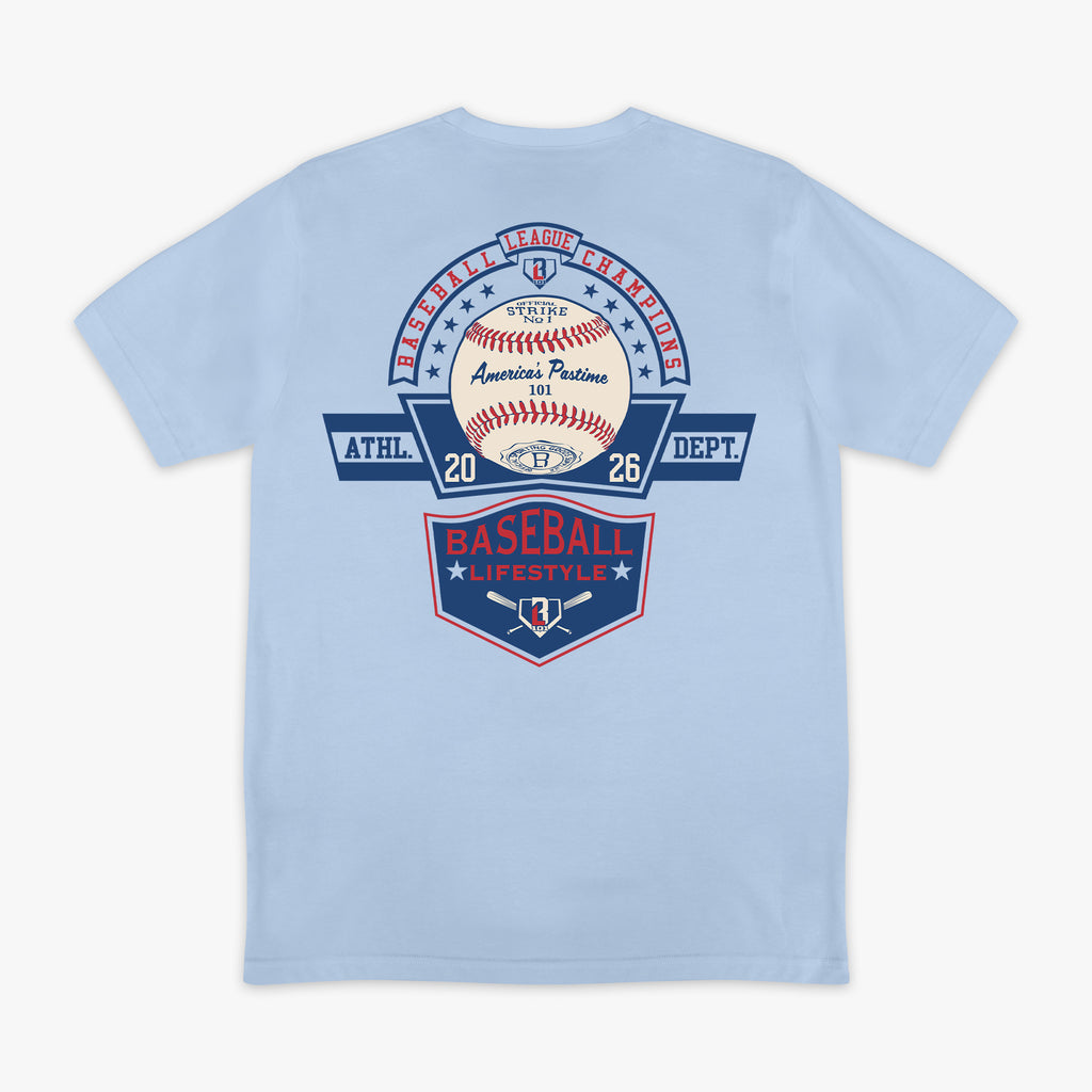 ack flat lay of the BL101 Baseball League Champions light blue tee, featuring a vintage-style "America's Pastime" baseball and Baseball Lifestyle shield graphic on a white background.