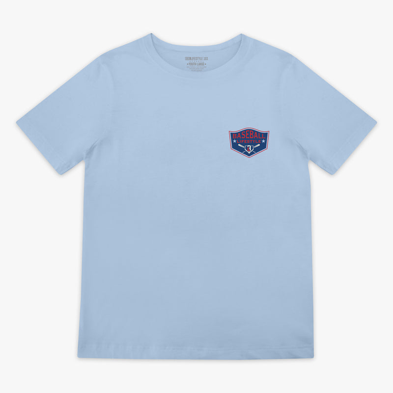 Front flat lay of the BL101 Baseball League Champions light blue tee, showing the Baseball Lifestyle shield chest logo on a white background.