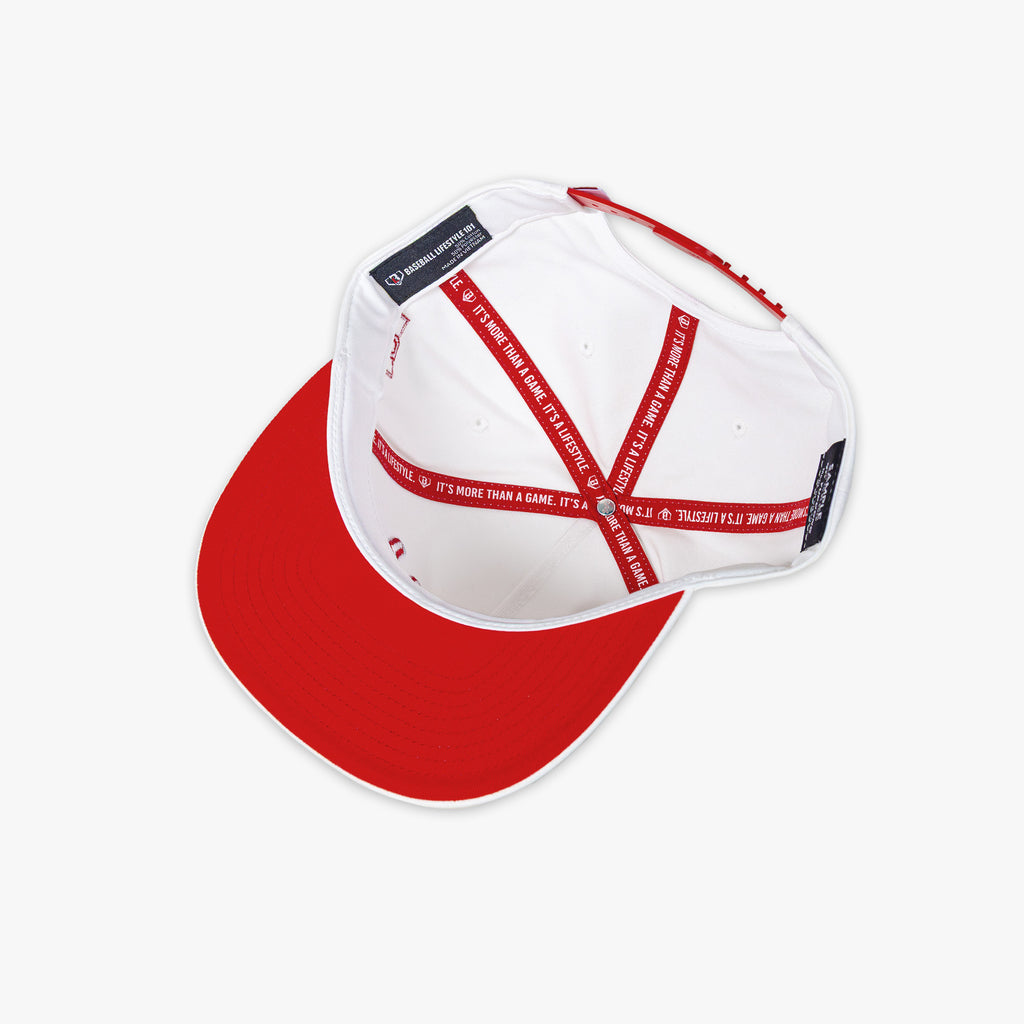 White and red cap with 'Baseball Lifestyle 101' tag on a white background