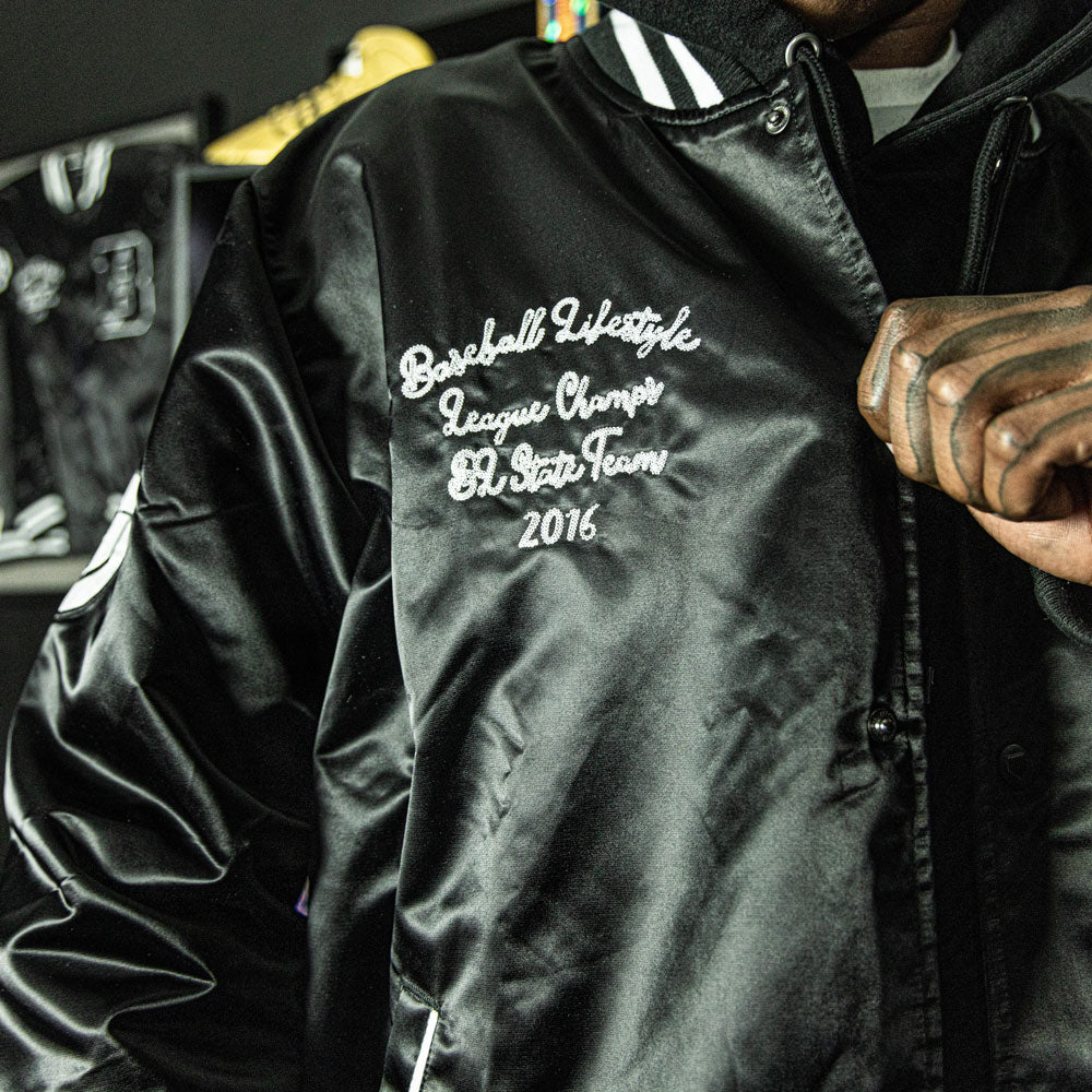 Jacket with “Baseline Satin Jacket” design — front view