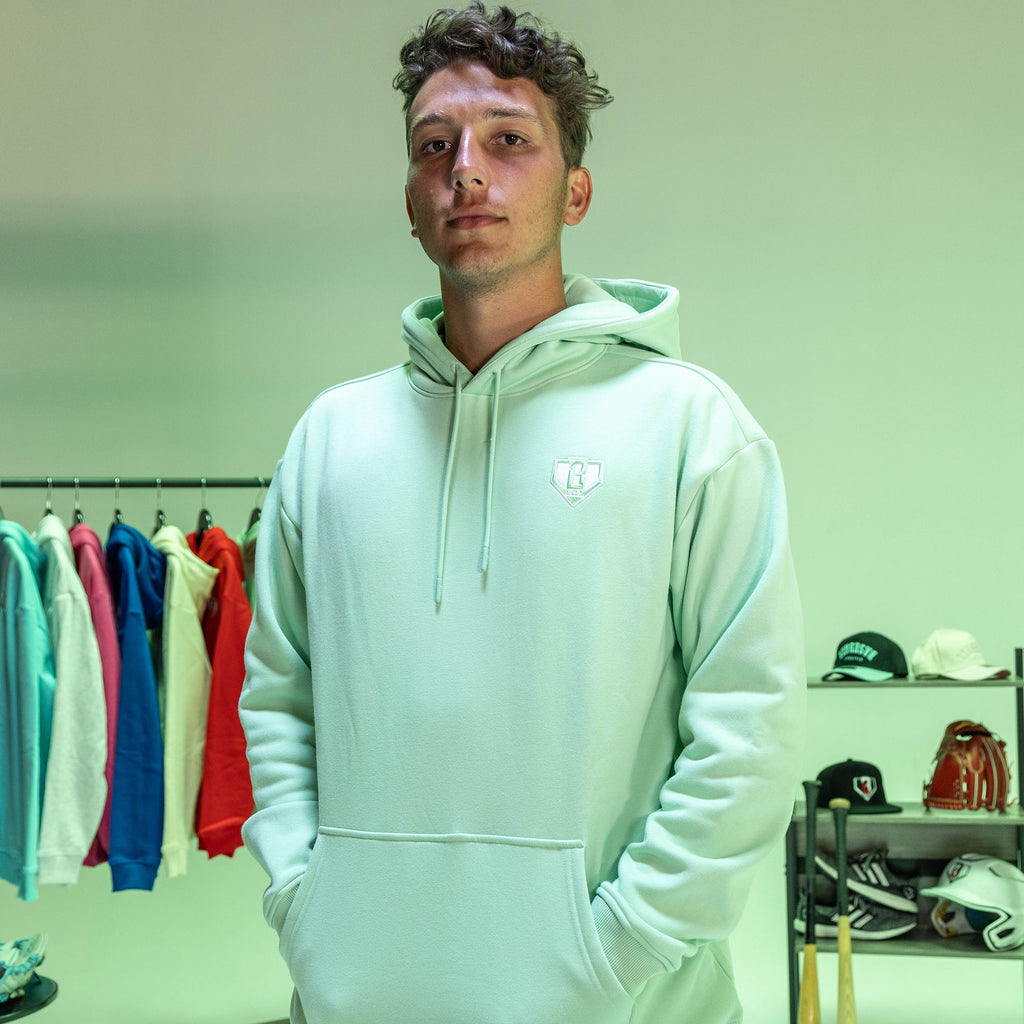 Man wearing a light green hoodie with BL101 logo in front of a green background