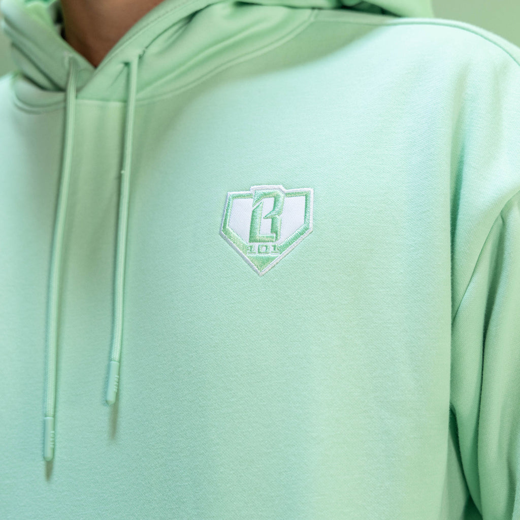 Light green hoodie with a BL101 logo on the chest against a neutral background
