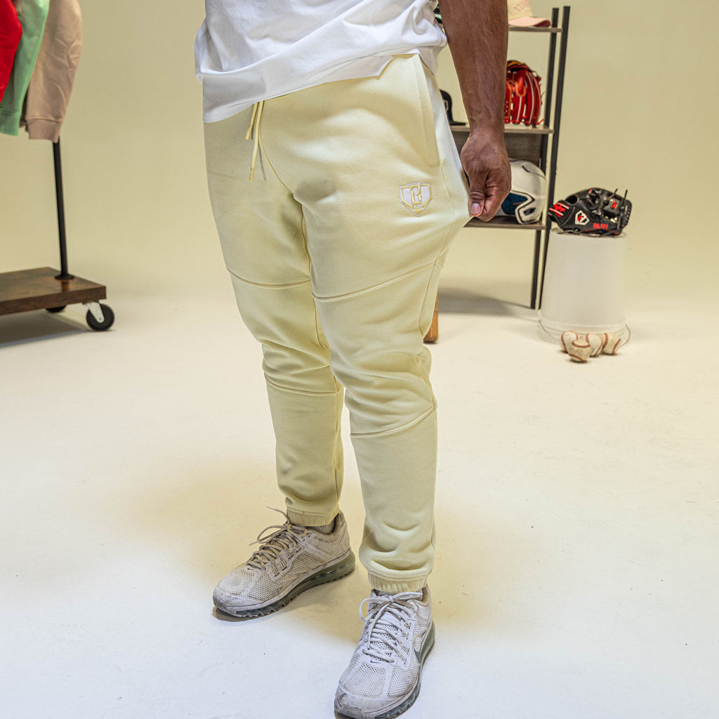 Person wearing yellow sweatpants with BL101 logo