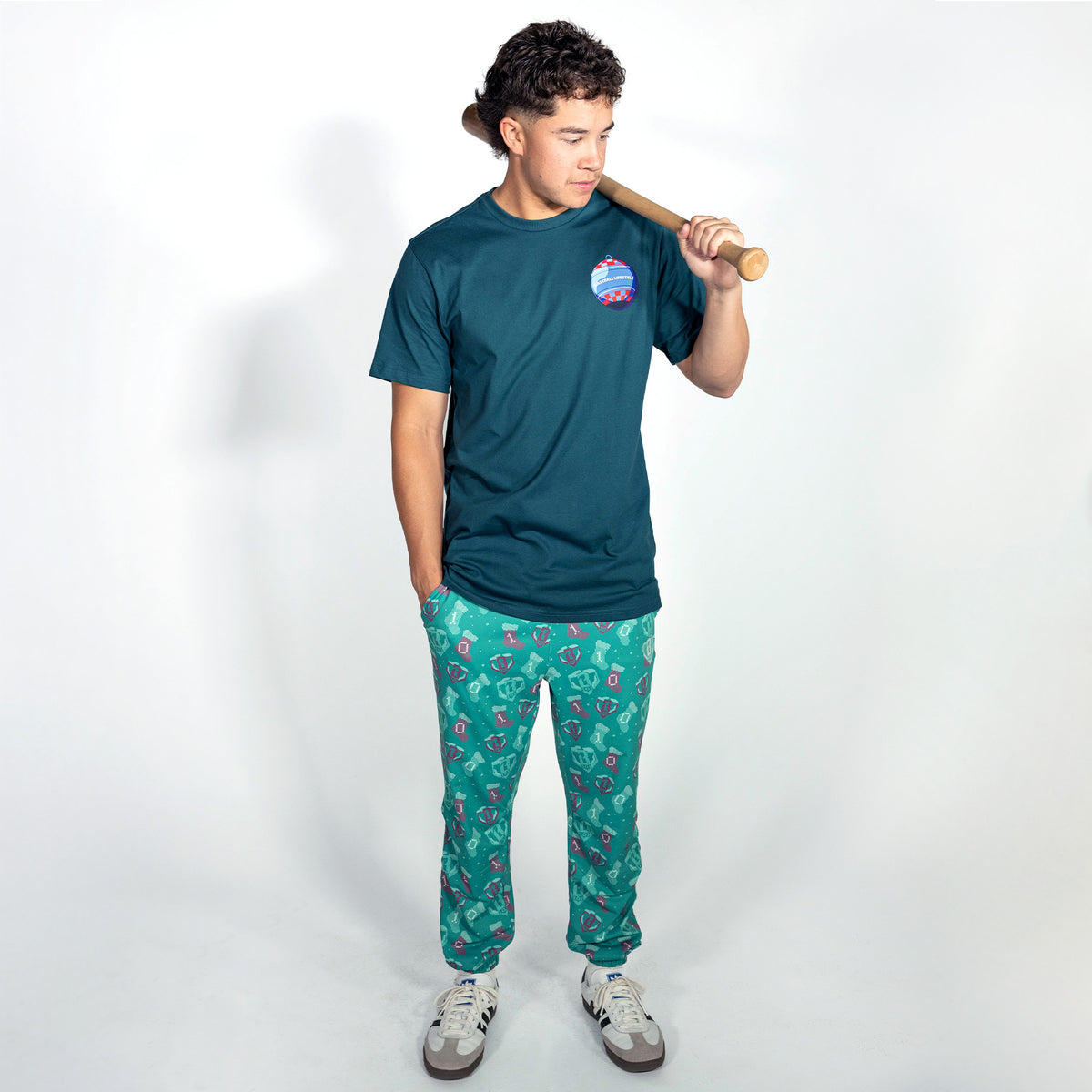 Adult model wearing teal graphic tee with "Bat Cracker" design