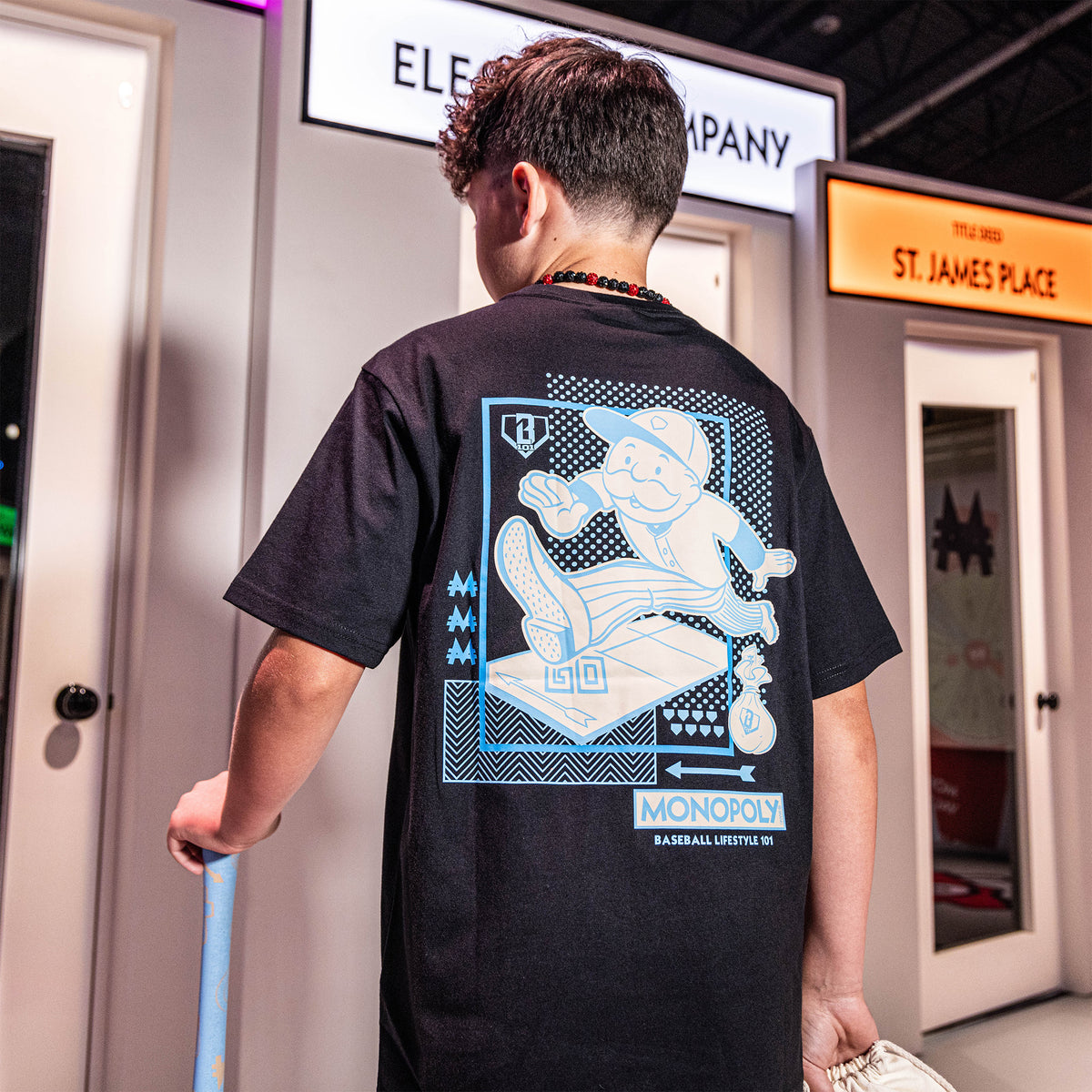 Youth model wearing youth graphic tee with “Boardwalk Slugger” design