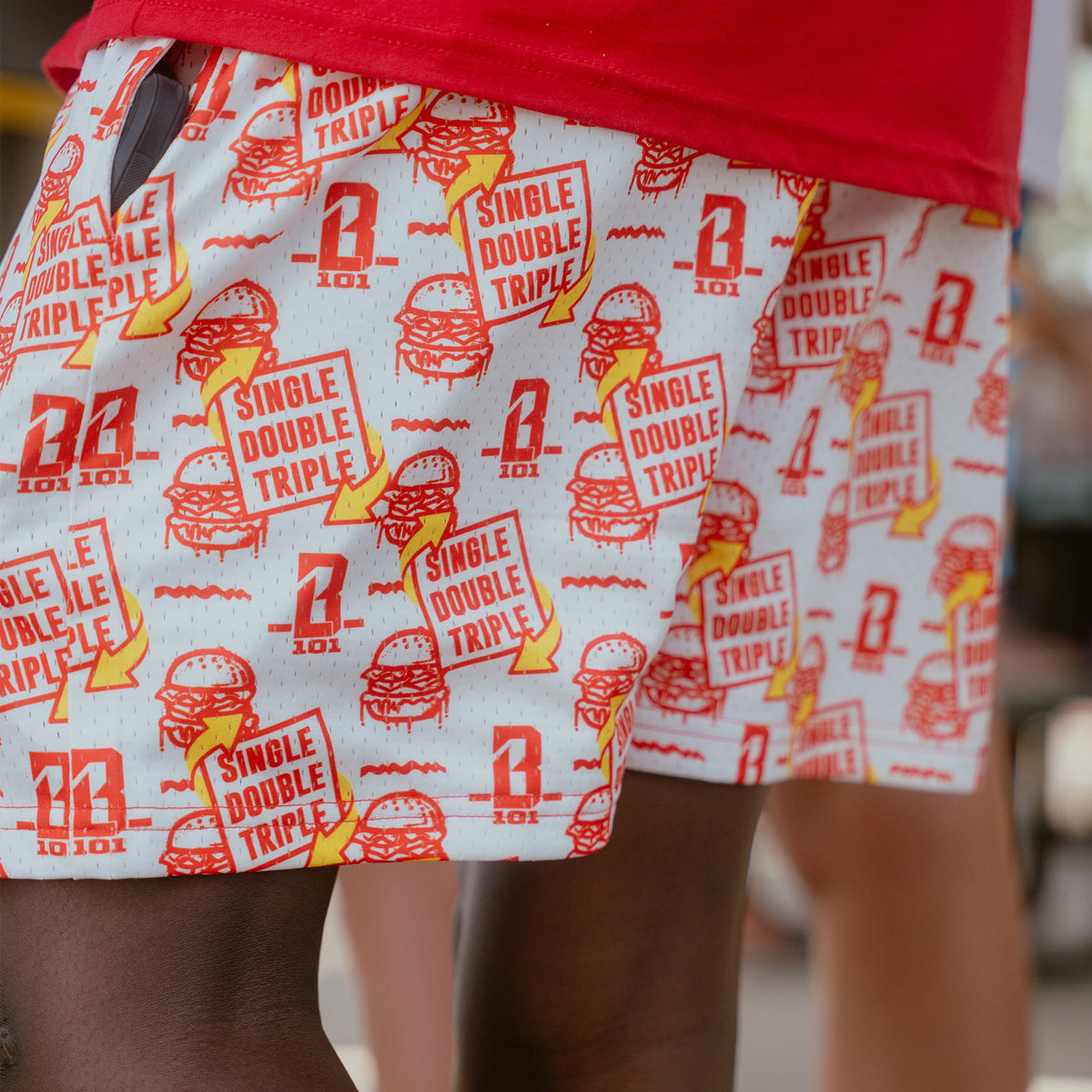 Adult model wearing shorts with "Burger" design