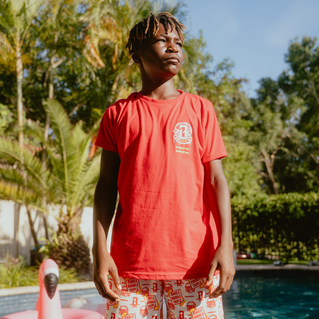 Youth model wearing youth graphic tee with "Burger" design