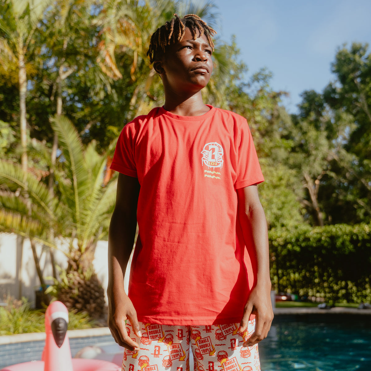 Youth model wearing youth graphic tee with "Burger" design