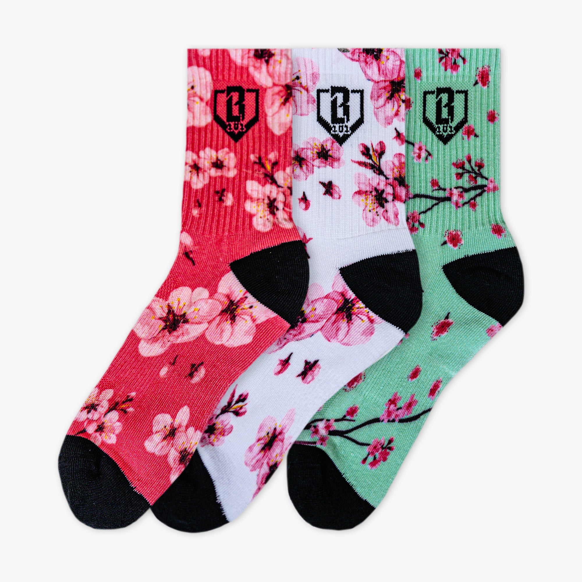 Adult model wearing multi-color socks with "Cherry Blossoms Performance  3-Pack" design