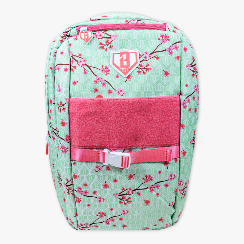 Backpack with cherry blossom pattern and pink accents on a white background