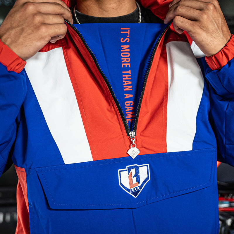 Person wearing a blue, red, and white jacket with 'IT'S MORE THAN A GAME' text and BL101 logo on chest.