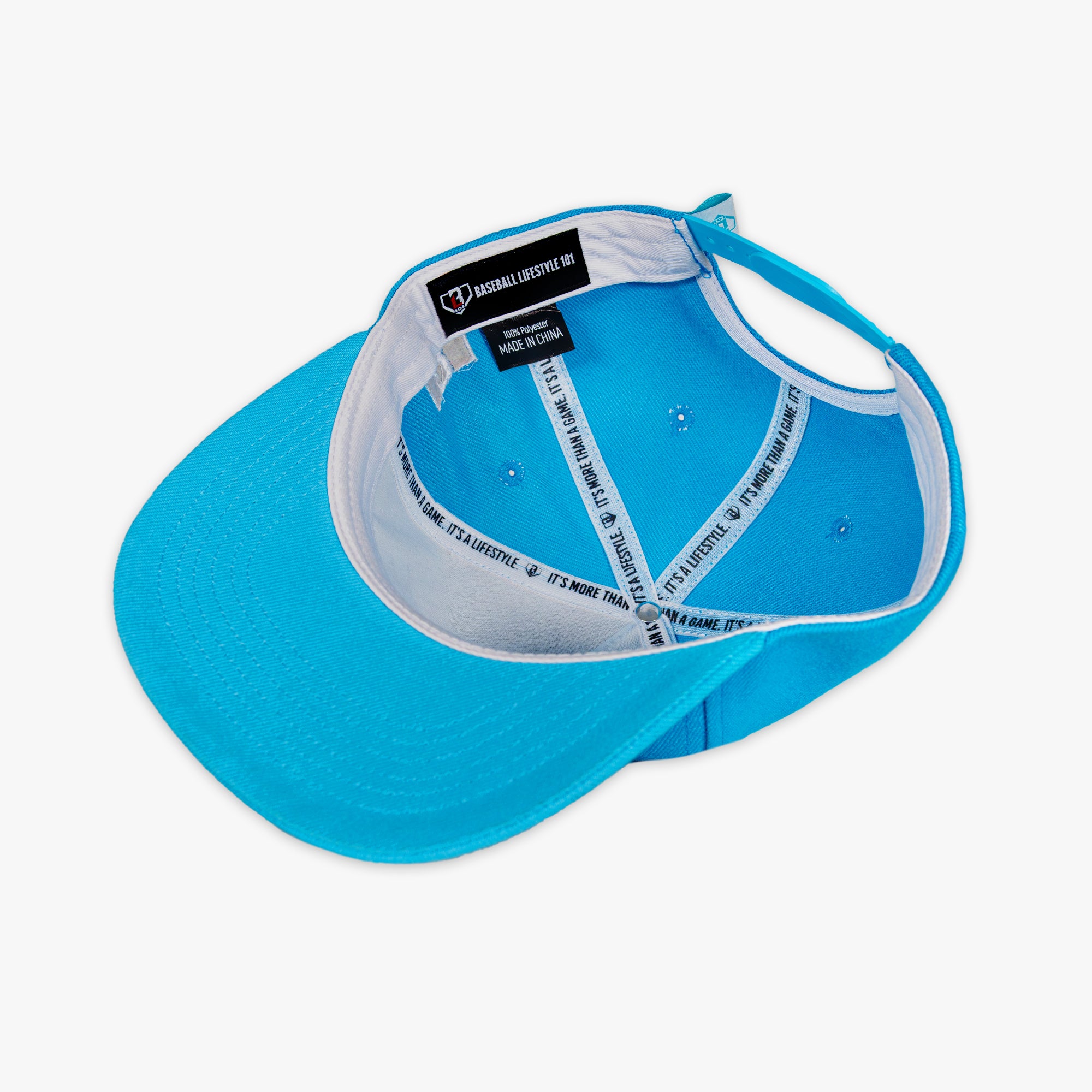 Blue cap with white interior and brand label on a white background
