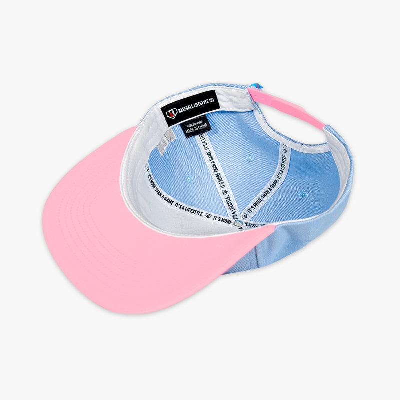 Two-toned pink and blue cap with a visible brand label on a white background