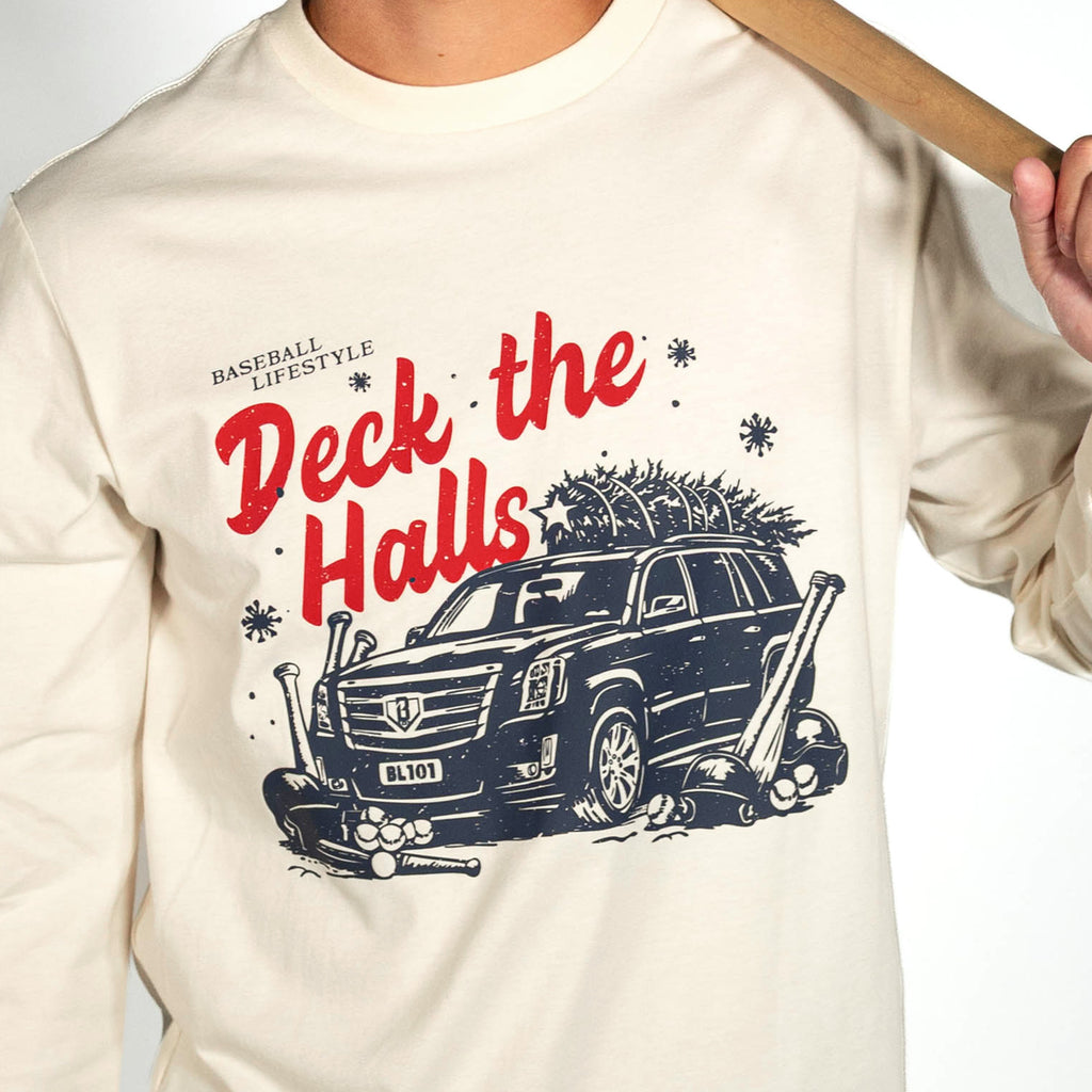 Adult model wearing white graphic tee with "Deck The Halls Long Sleeve" design