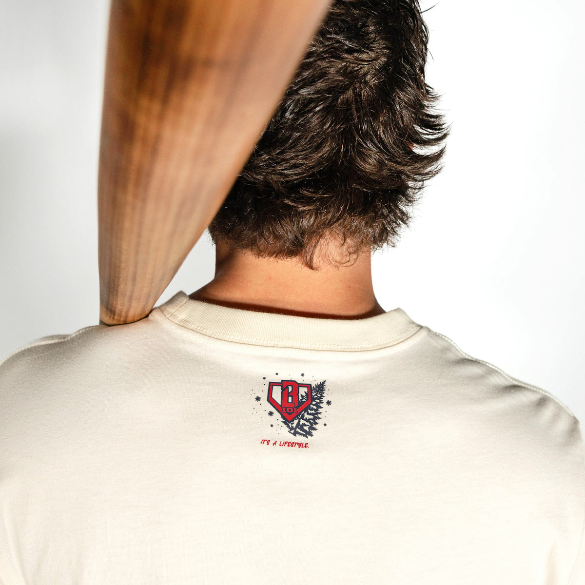 Adult model wearing white graphic tee with "Deck The Halls Long Sleeve" design