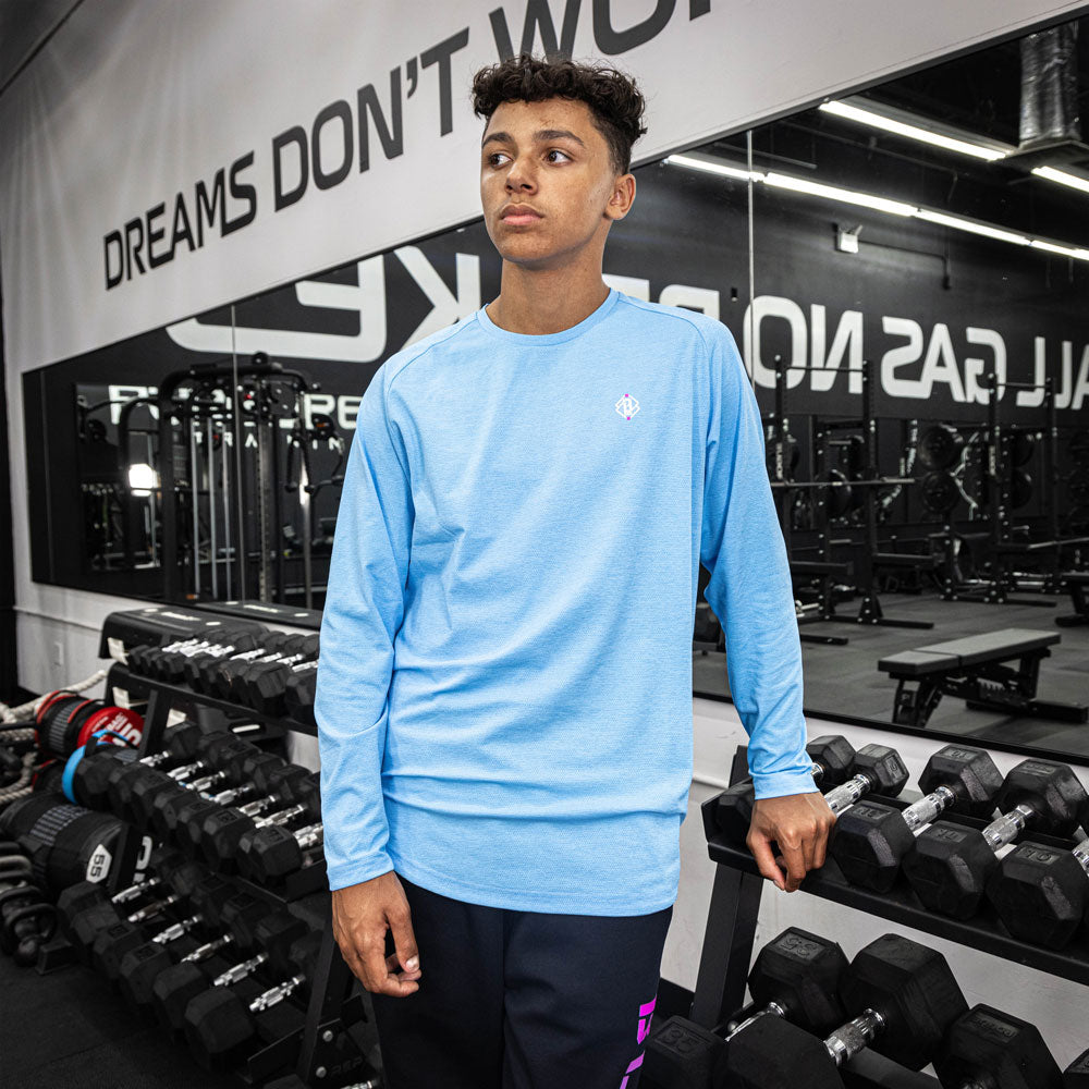 Adult model wearing blue Diamond Tech Long Sleeve Cotton Candy Blue long sleeve tee