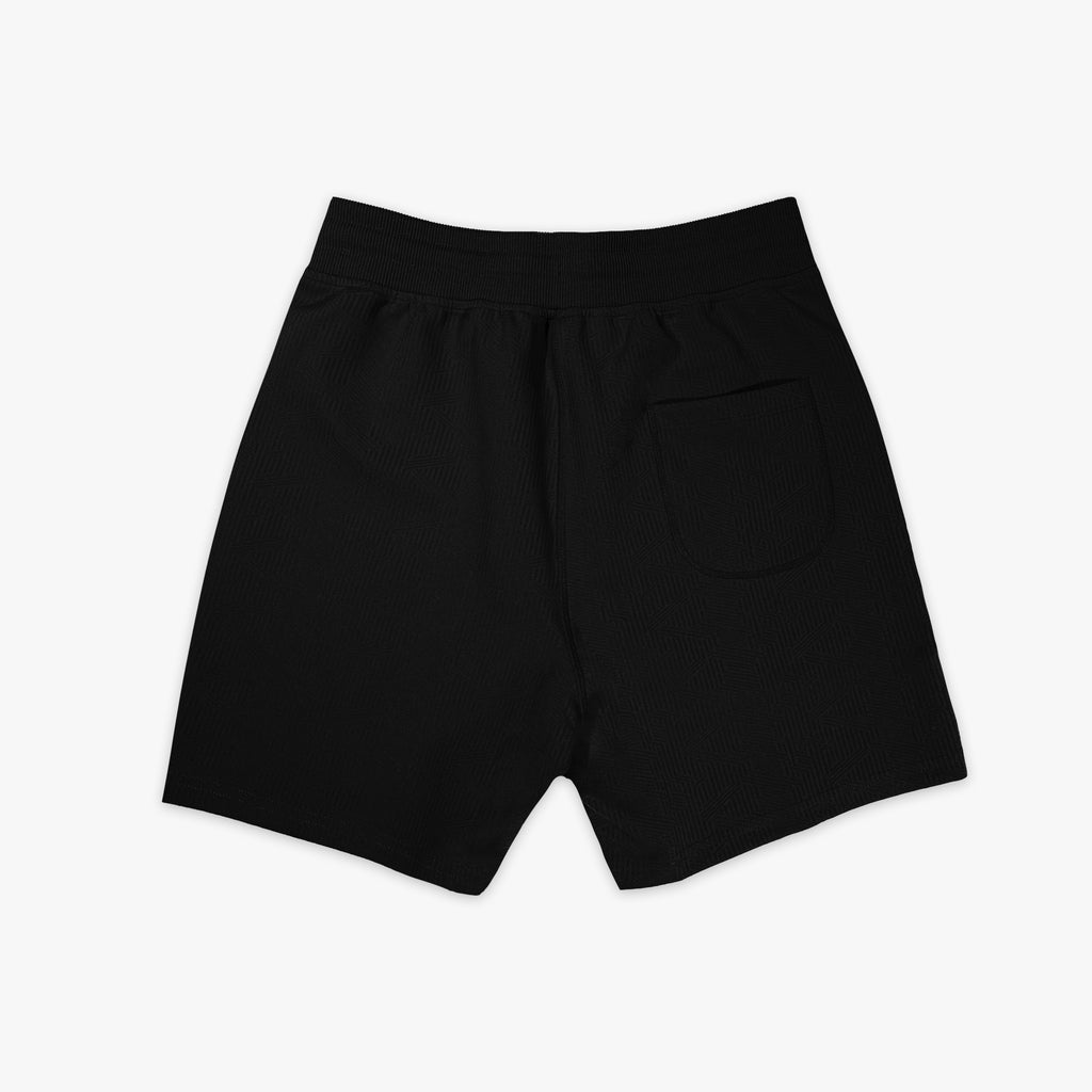 Black shorts with a small logo on a white background