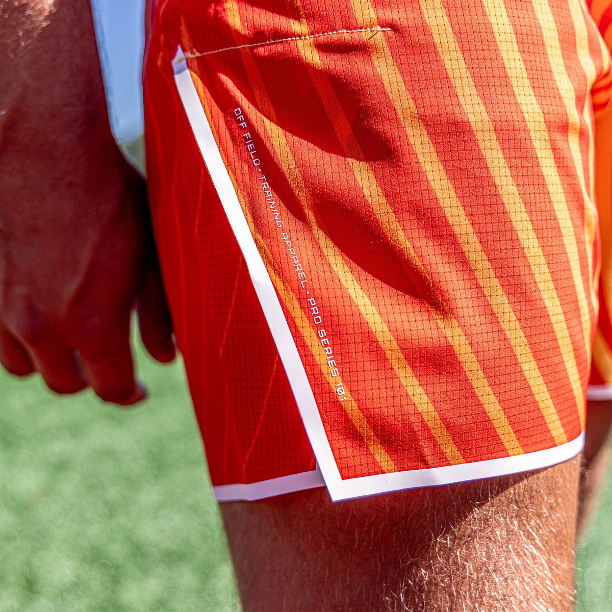 Adult model wearing orange Diamond Tech with Liner Orange Gradient shorts