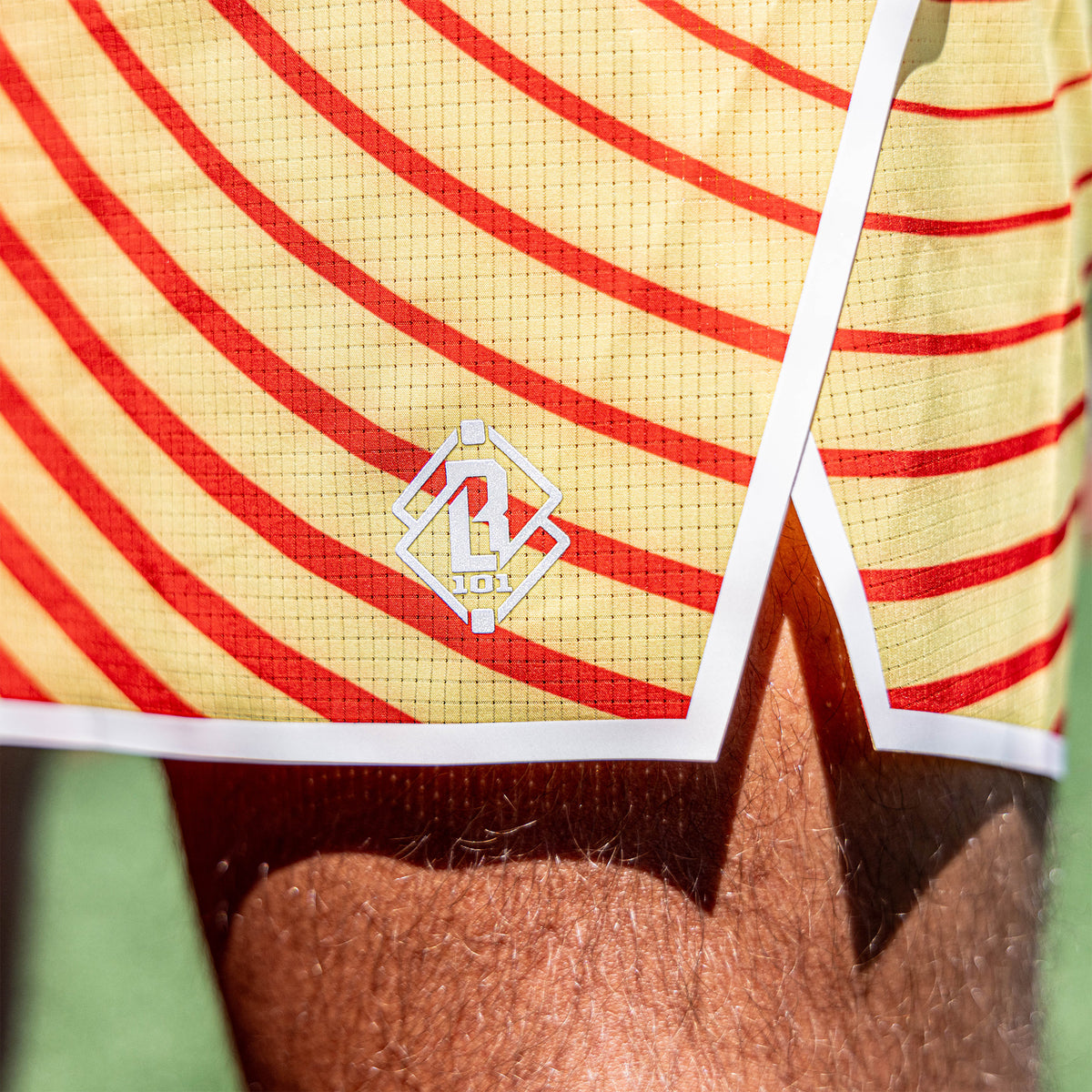 Adult model wearing orange Diamond Tech with Liner Orange Gradient shorts