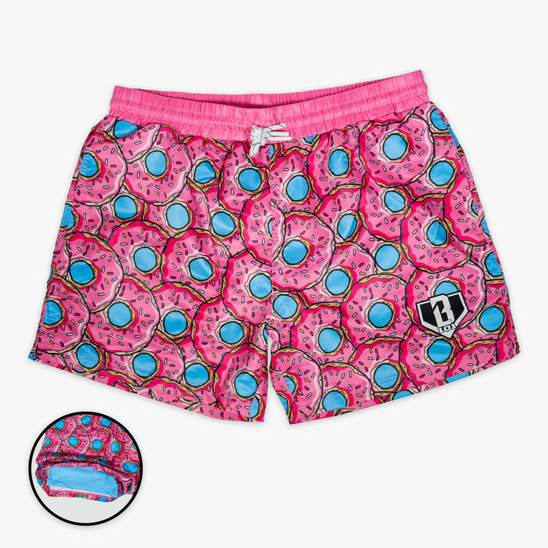 Pink swim shorts with donut pattern on a white background