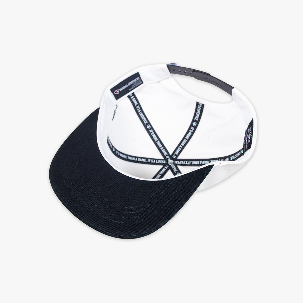 White and black baseball cap with 'Baseball Lifestyle' tag on a white background
