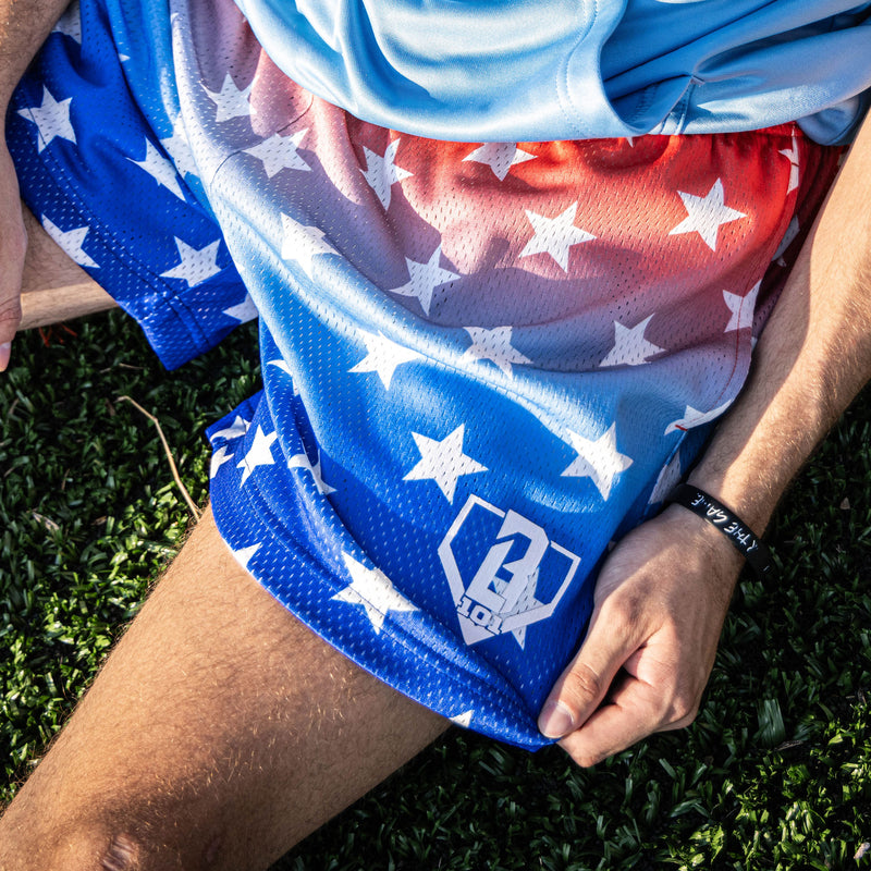 Youth model wearing red Gradient Freedom youth shorts