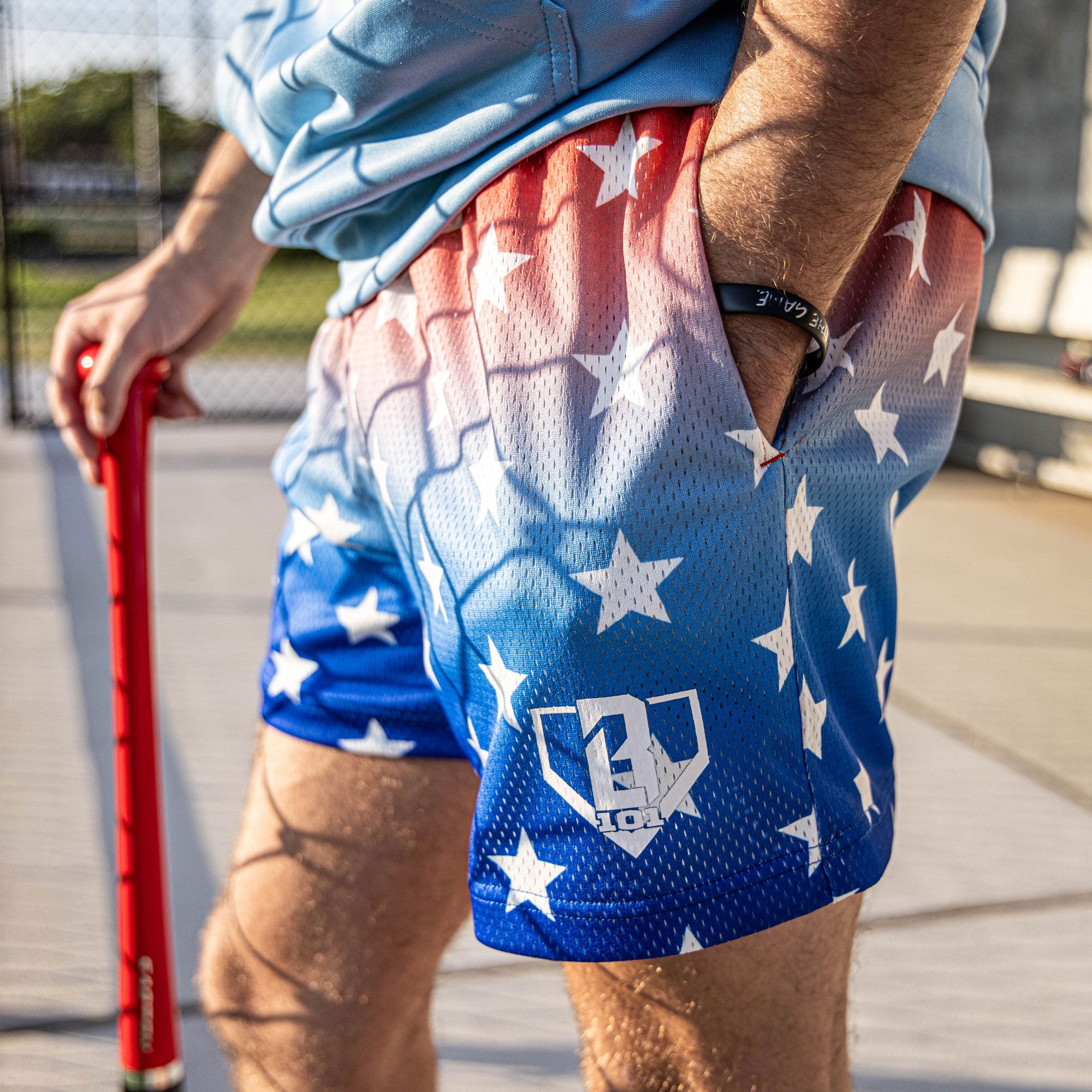 Youth model wearing red Gradient Freedom youth shorts