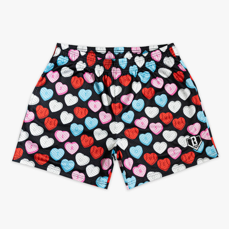 Black shorts with colorful heart pattern and letters on a black background