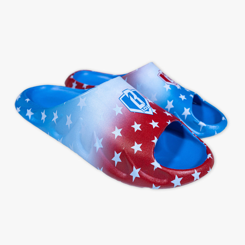 BL101 slides featuring a red, white, and blue star print with a gradient ombre design and BL101 home plate logo on each strap.