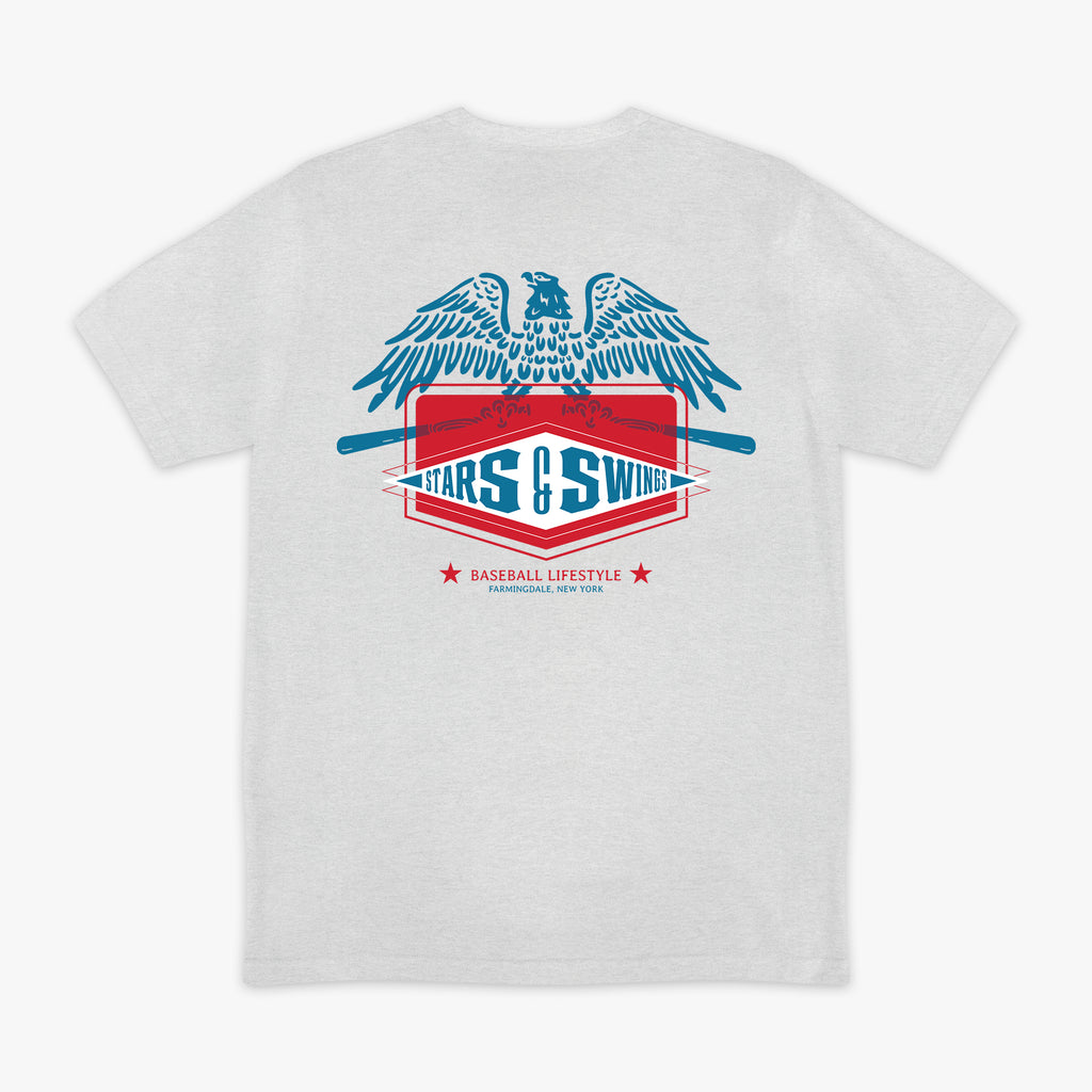 Heather gray short sleeve tee with blue spread-wing eagle above Stars and Swings badge graphic with crossed bats and Baseball Lifestyle Farmingdale New York text on white background