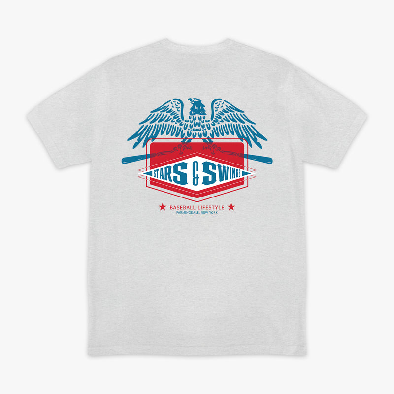 Heather gray short sleeve tee with blue spread-wing eagle above Stars and Swings badge graphic with crossed bats and Baseball Lifestyle Farmingdale New York text on white background