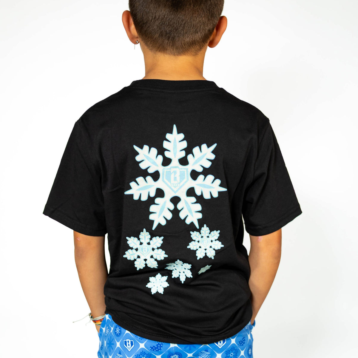 Youth model wearing black youth graphic tee with "Frozen Diamond" design