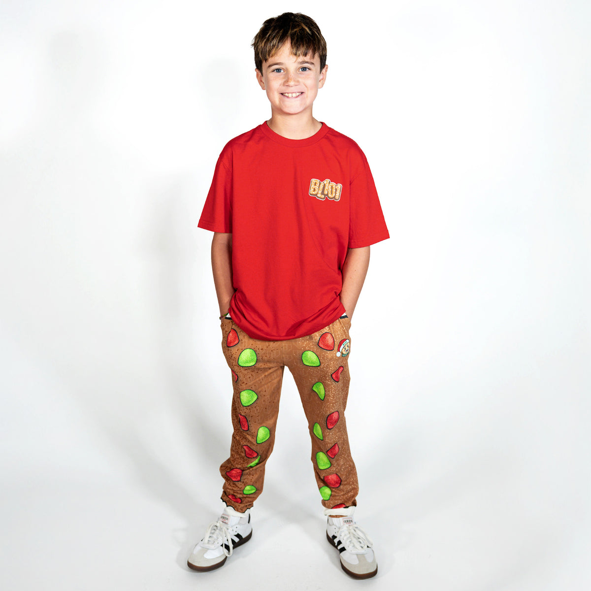 Youth model wearing red youth graphic tee with "Gingerbread Stadium" design