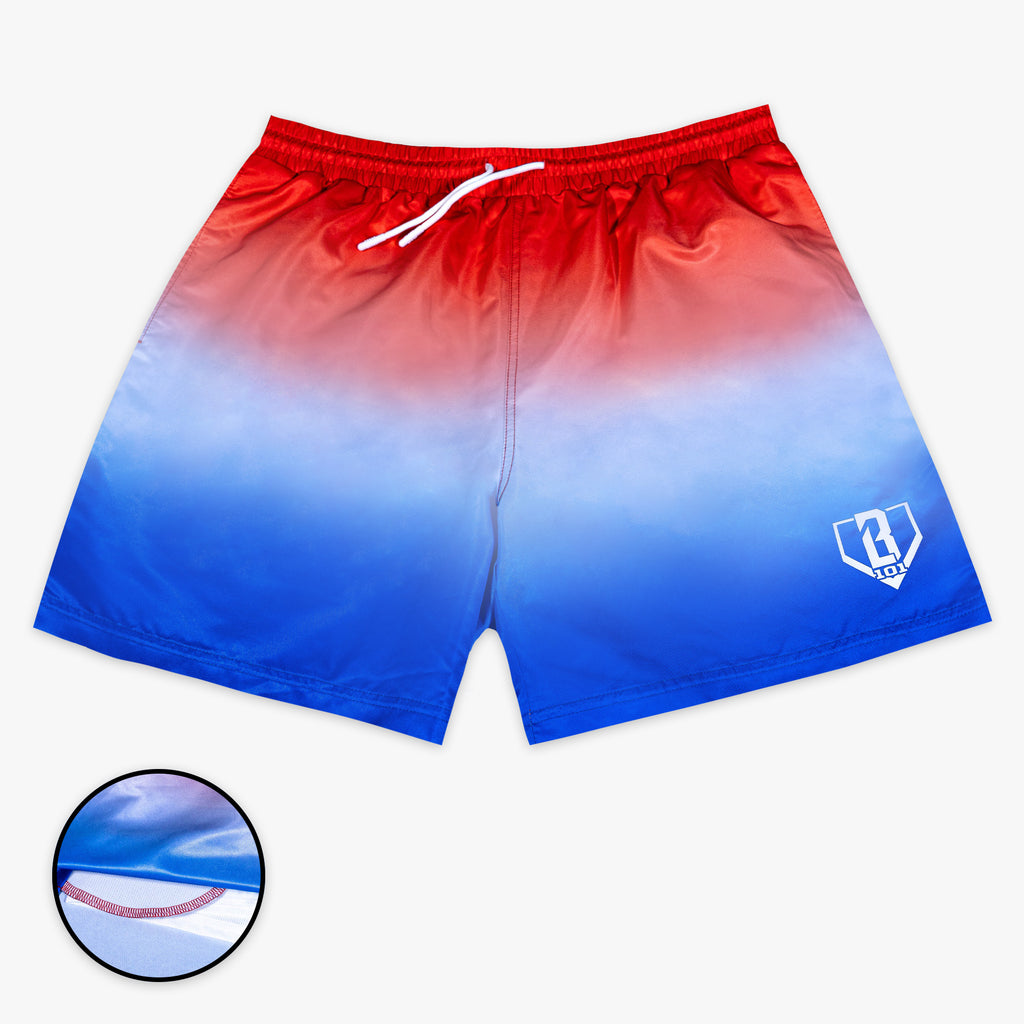 Front flat lay of BL101 red to blue ombre swim trunks with a white drawstring and BL101 home plate logo on the leg.
