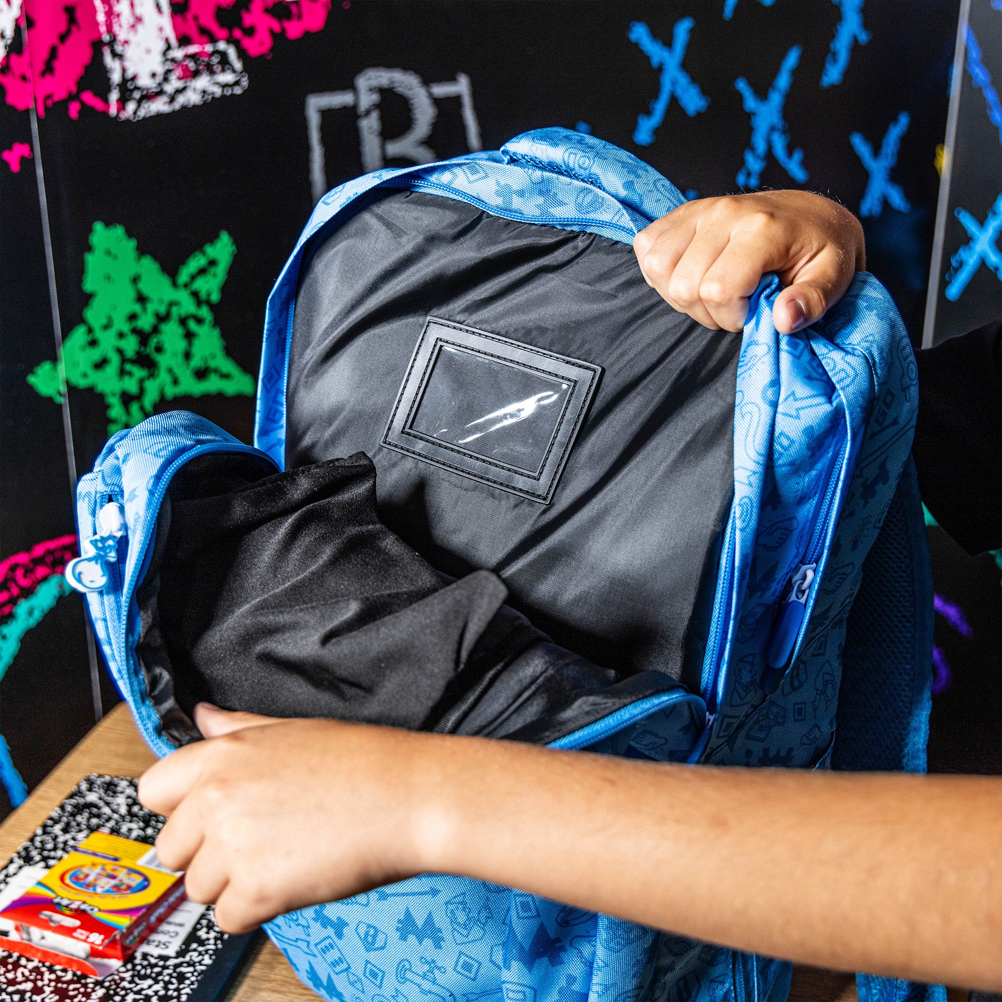 Adult model wearing backpack with “Grand Slam Collector SZN 2” design