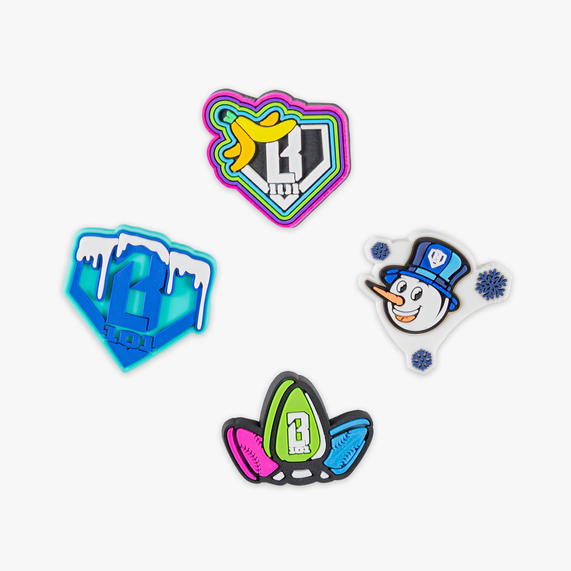 Four colorful jibbitz with different designs on a white background