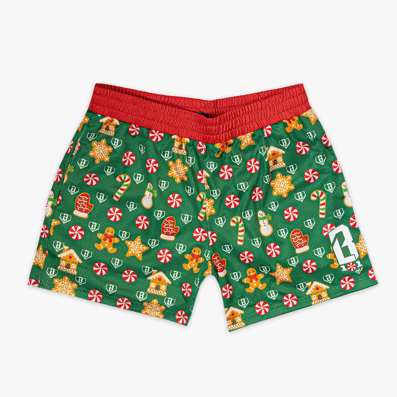 Green shorts with Christmas-themed pattern on a white background