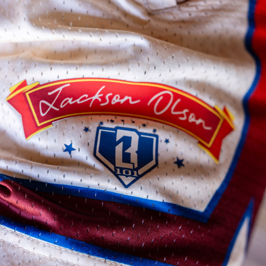 Close-up of shorts with 'Jackson Olson' text and 'BL101' logo 