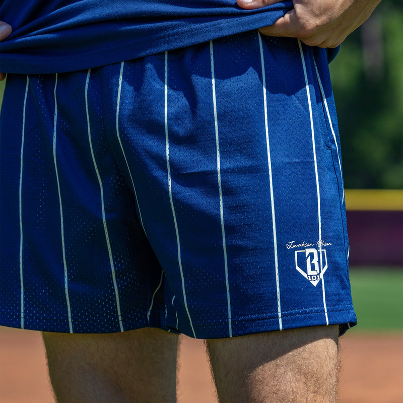 Person wearing blue striped shorts with beige waistband and white BL101 logo