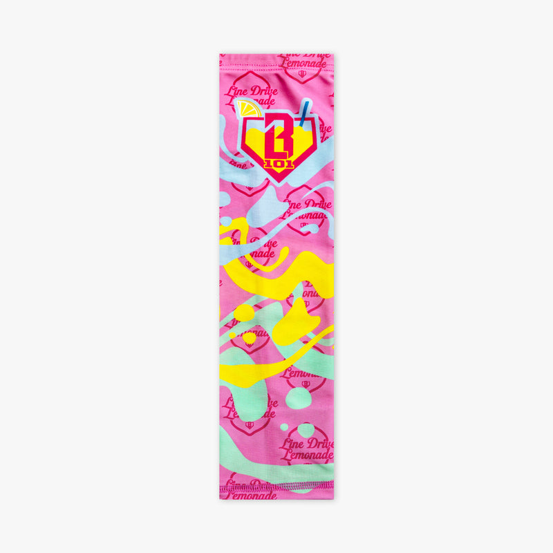 Youth model wearing pink youth arm sleeve with "Lemon Burst" design