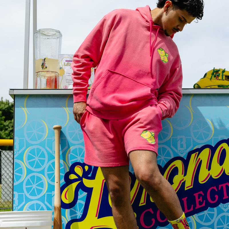 Adult model wearing pink shorts with "Lemon Dingers" design