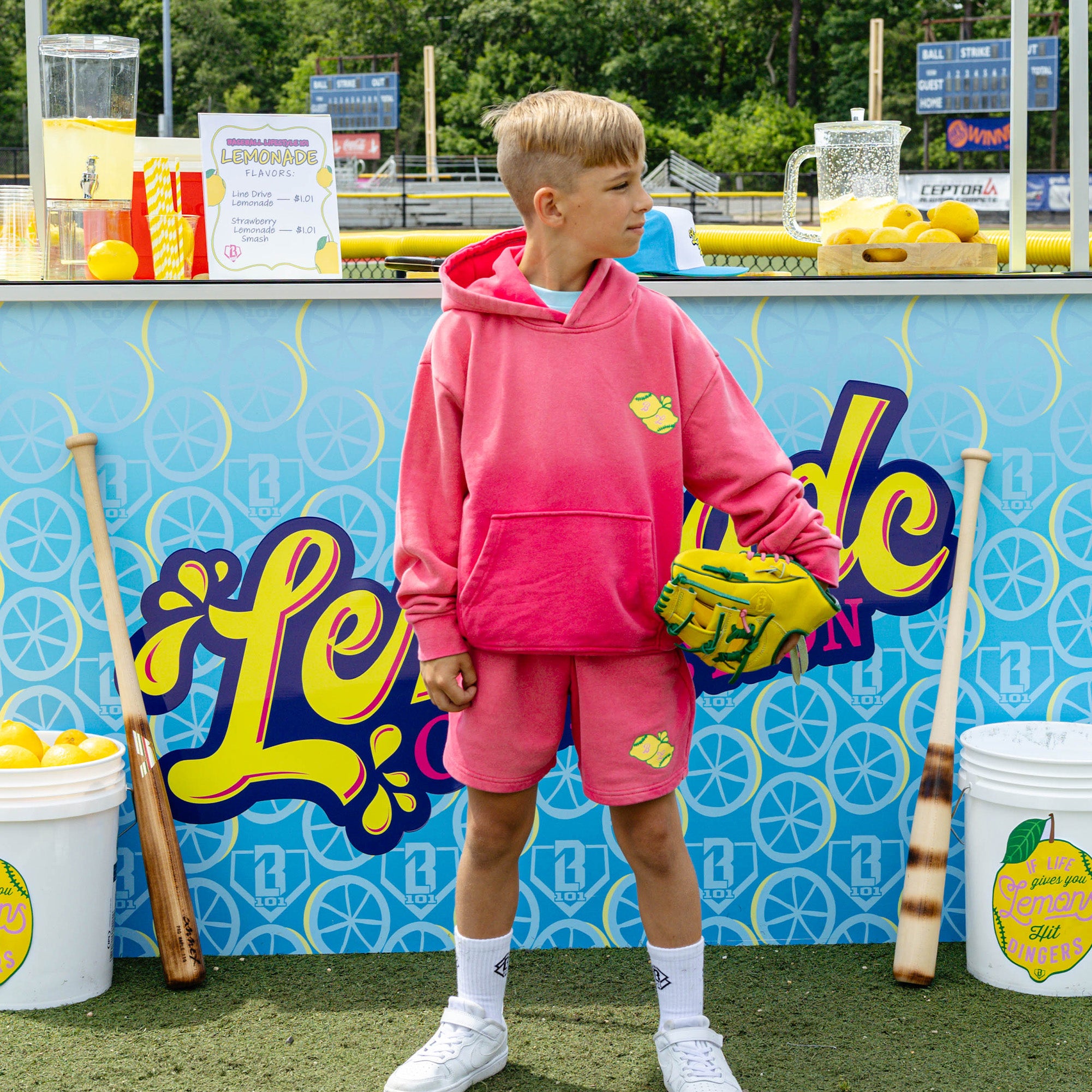 Youth model wearing pink youth shorts with "Lemon Dingers" design