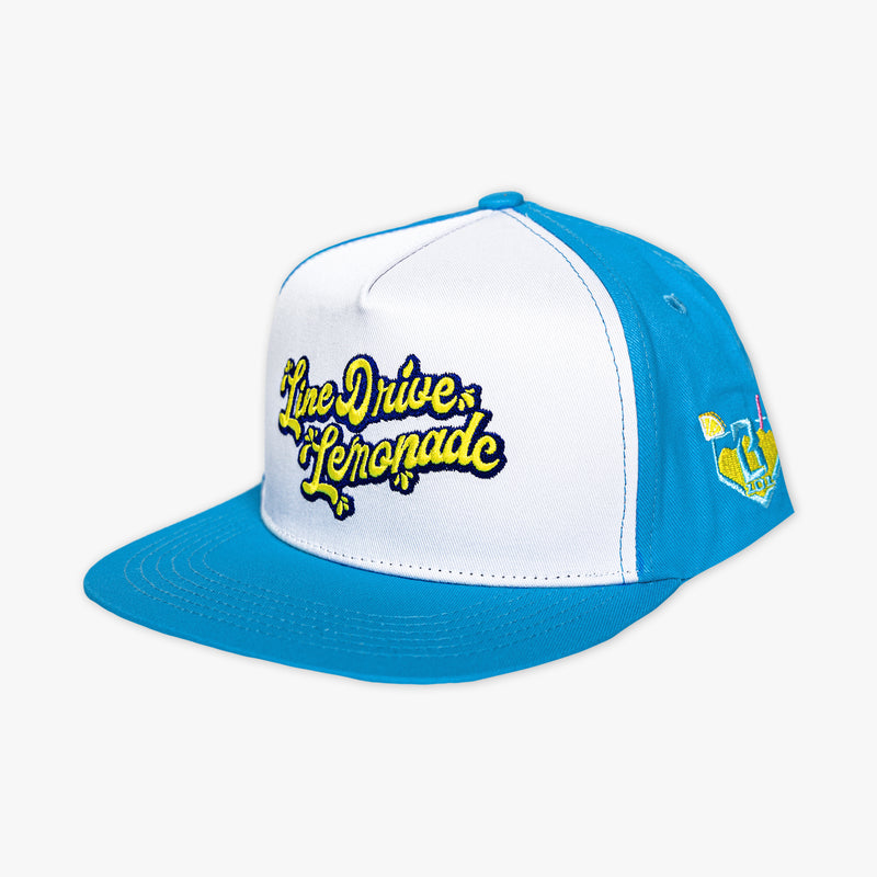 Adult model wearing blue hat with "Lemonade Off Field" design