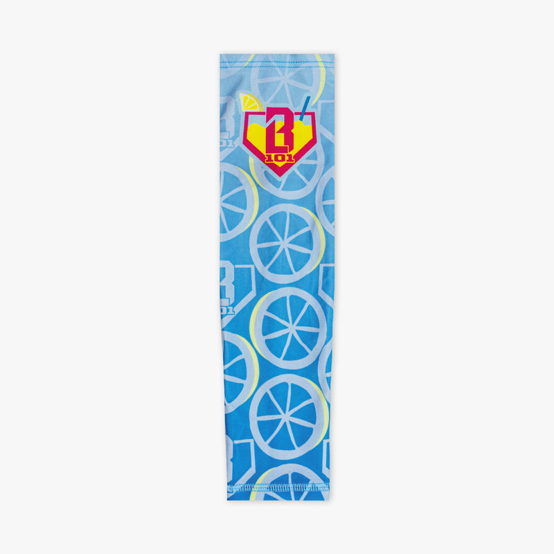 Youth model wearing blue youth arm sleeve with "Lemonade Splash" design